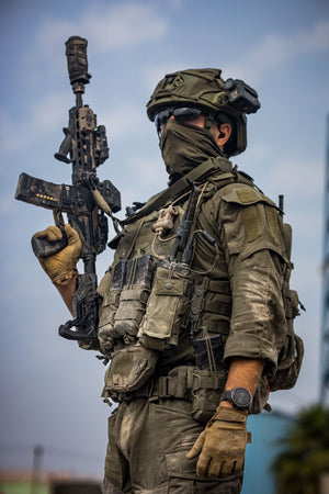 Soldier in full gear with Silynx Clarus II. holding a rifle against a clear sky