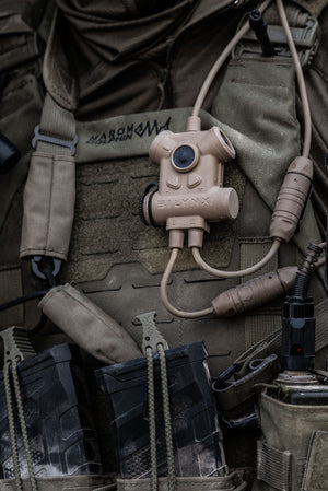 Silynx Clarus II Tactical device attached to a military uniform with various gear in the background