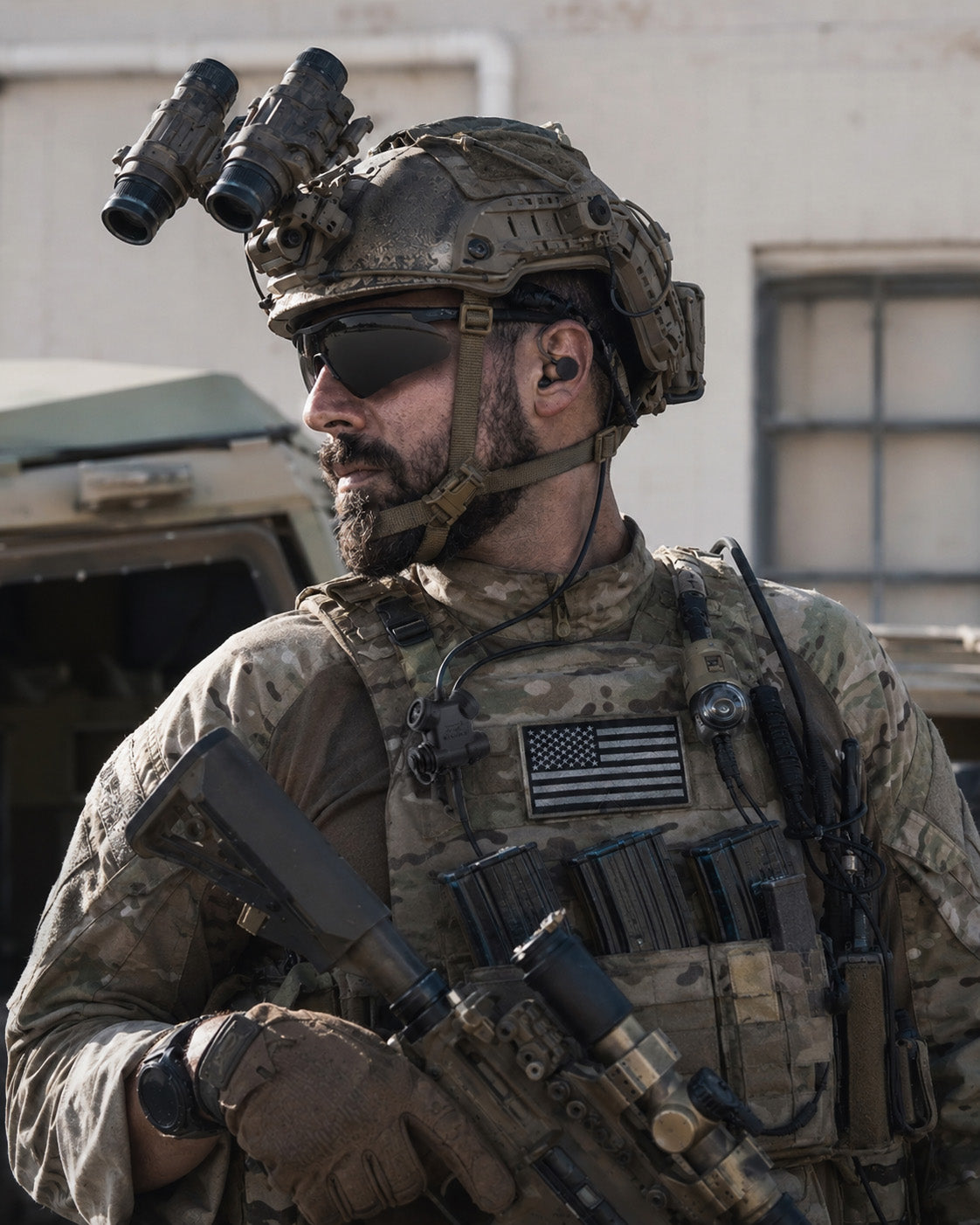 Soldier in camouflage gear with tactical equipmentת Silynx custom earmolds and Clarus control box. Outdoor setting