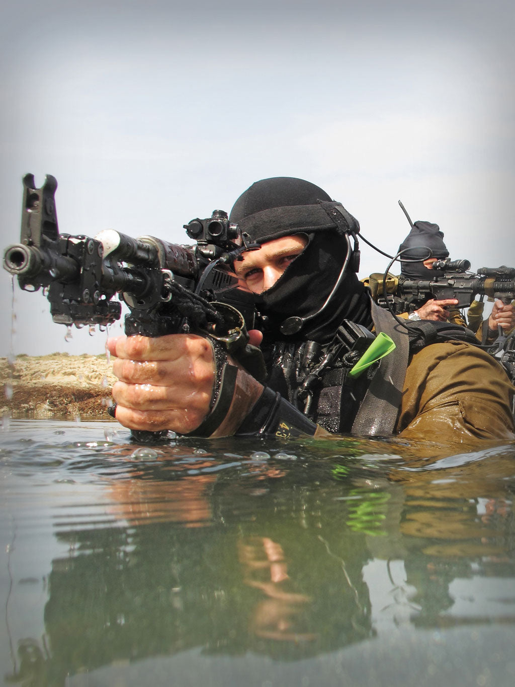 A Soldier with Silynx Eagle headset attached to a headband in water.