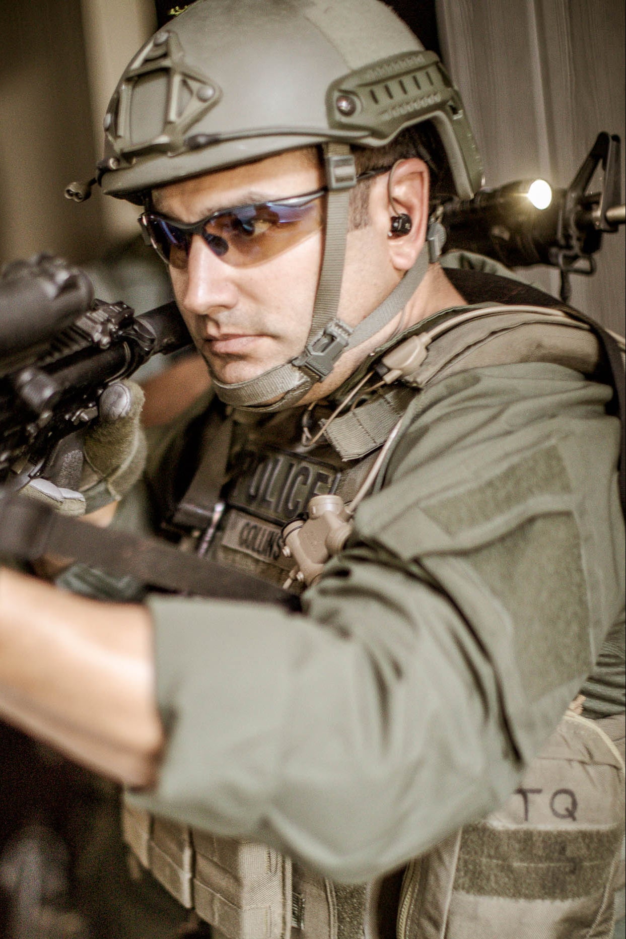 Soldier with Silynx CLarus Headset system in tactical gear holding a rifle with a blurred background