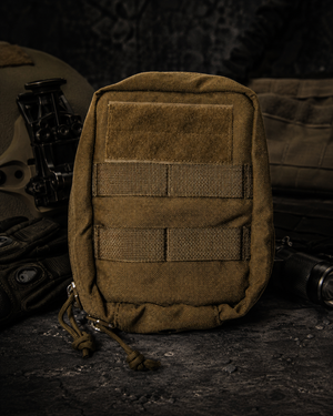 Silynx Tan tactical pouch with multiple MOLLE straps on a dark background