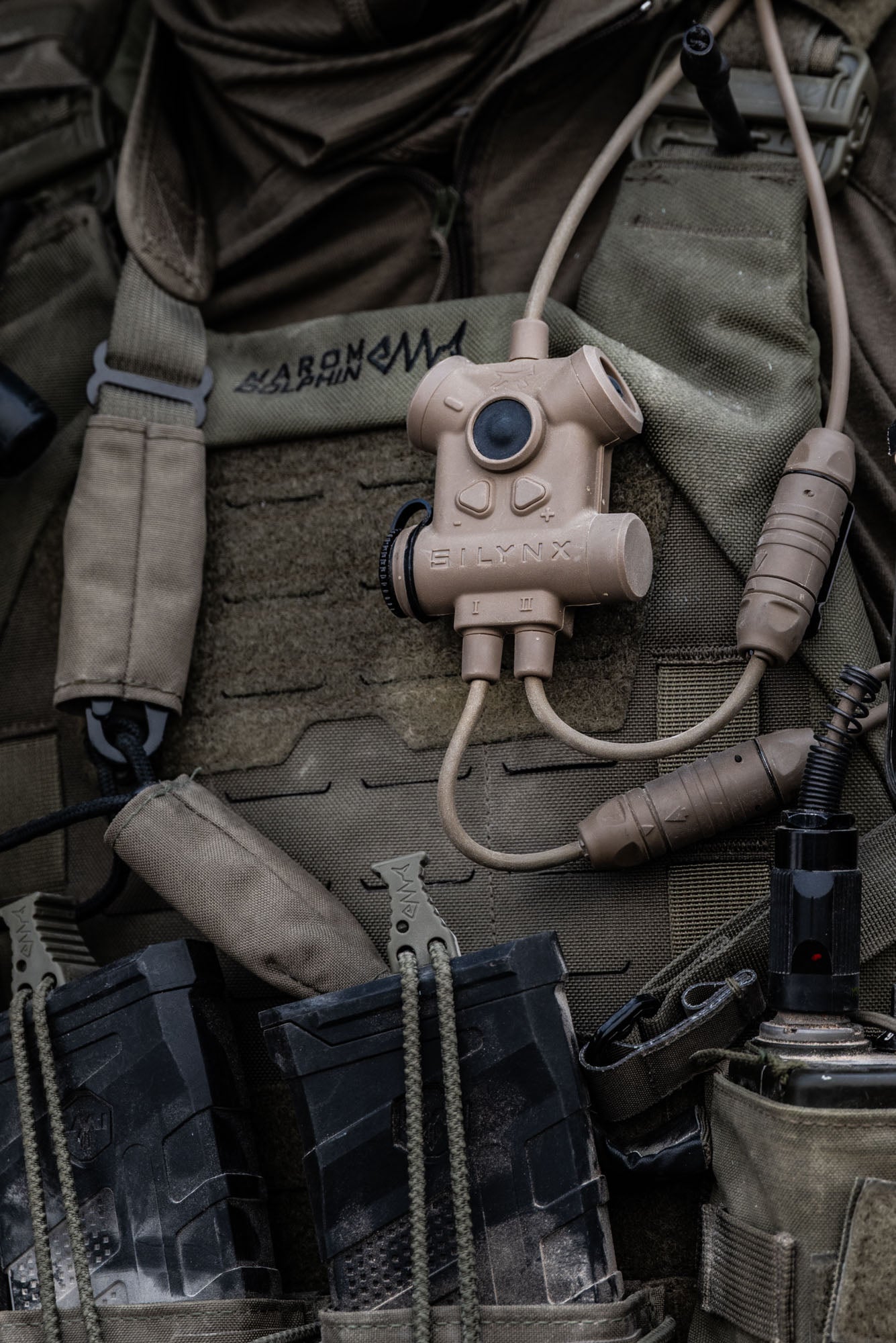 Silynx Clarus II  Tactical device attached to a military uniform with various gear in the background