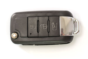 Top View of Silynx KeyFob Covert PTT - Black remote control look alike keychain on a white background