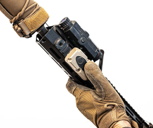 Hand holding a rifle pressing on Silynx Wireless PTT
