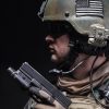 United states Marine Corps special operations command Marsoc raider with pistol. Studio shot of Marine Special Operator black background