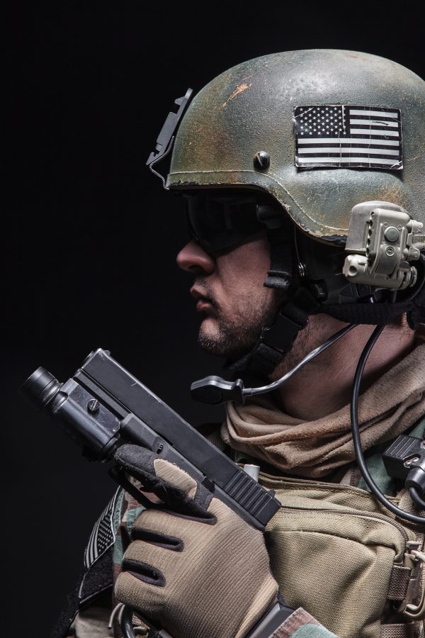 United states Marine Corps special operations command Marsoc raider with pistol. Studio shot of Marine Special Operator black background